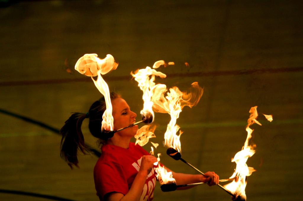 Former Golden Girl Chelsea Russell twirls fire during pep rally.