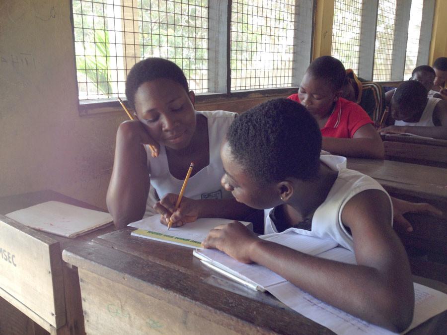 Students in a Ghanian high school do schoolwork. 