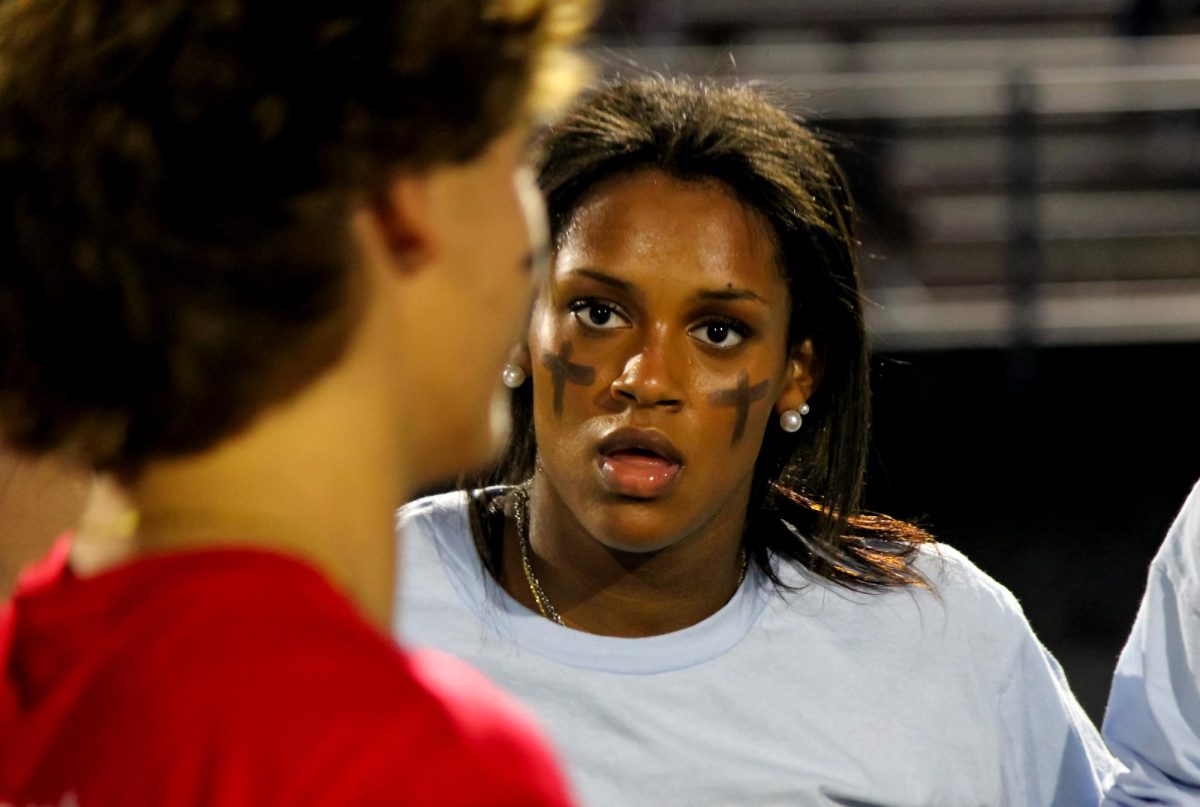 STARE DOWN THE COACH:  Running back Ruth Cloyd 25 listens to the play call during the homecoming PowderPuff football game.