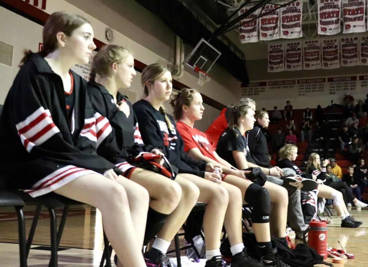 Hazel Boerner ’26, Cooper Hamilton ’26, Quinn Price ‘24, Sierra Pruessner ‘24 and Eliza Mitchell ‘27 watch as a tough match goes down.
