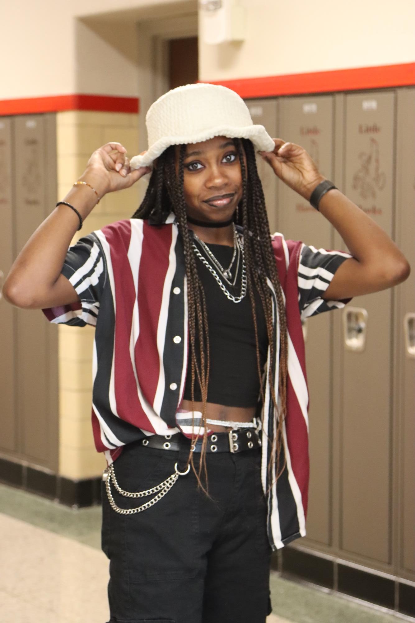 Dominique Jackson 24 poses with one of their crotchet bucket hats. 