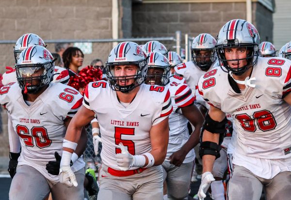 Drew Nye and the Little Hawk football team take the field at West High.