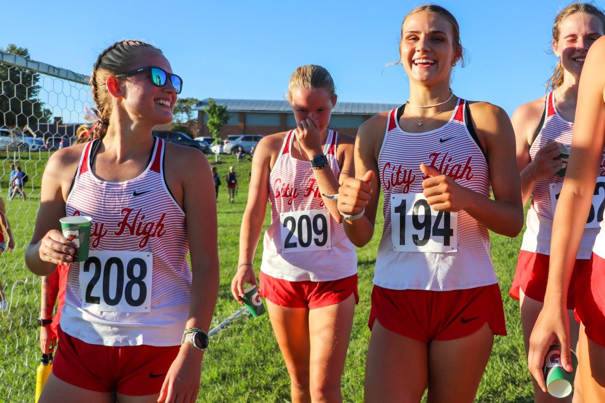 Nicole Peterson '25, Nina Peterson '25, and Grace Hamann '27 talk  post-race.