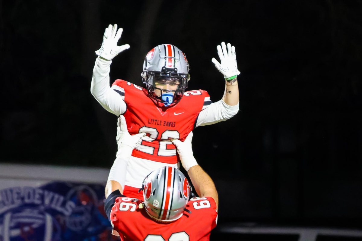 Tyler Rindles '25 lifts Gabriel Egeland '25 following a touchdown run to extend the lead.