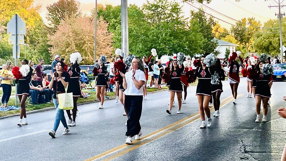 Coach Degner leads cheerleaders during the Homecoming Parade. 