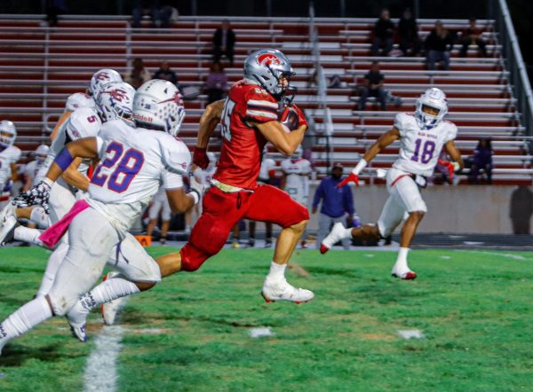 City High's wide receiver '25' dashes through Davenport Central's defense and scores the game's first touchdown