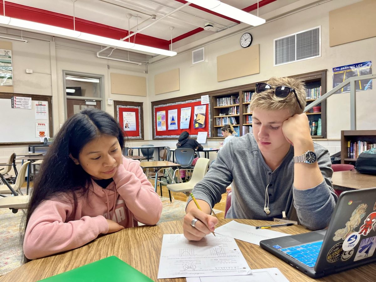 Mason Tilley '25 helps a peer with her geometry homework during third hour.