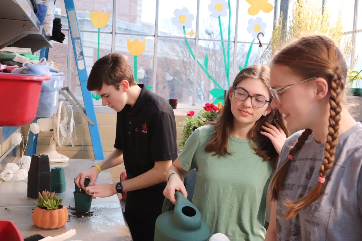 Lukas Iverson, Gwen Arab, and Zoee Noble all do there best to keep plants flourishing.