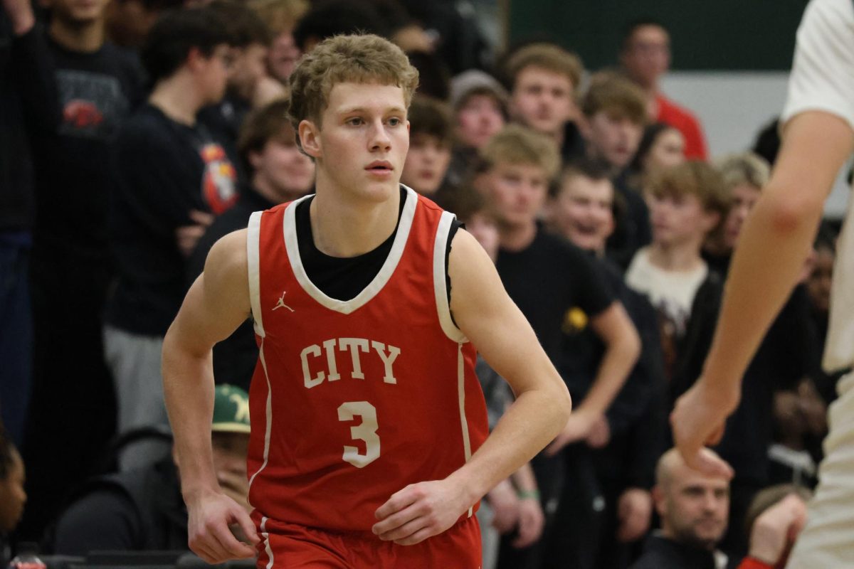 Starting guard Jack Lampe '26 runs up the court in rivalry game against West High. The team lost by four in that game.