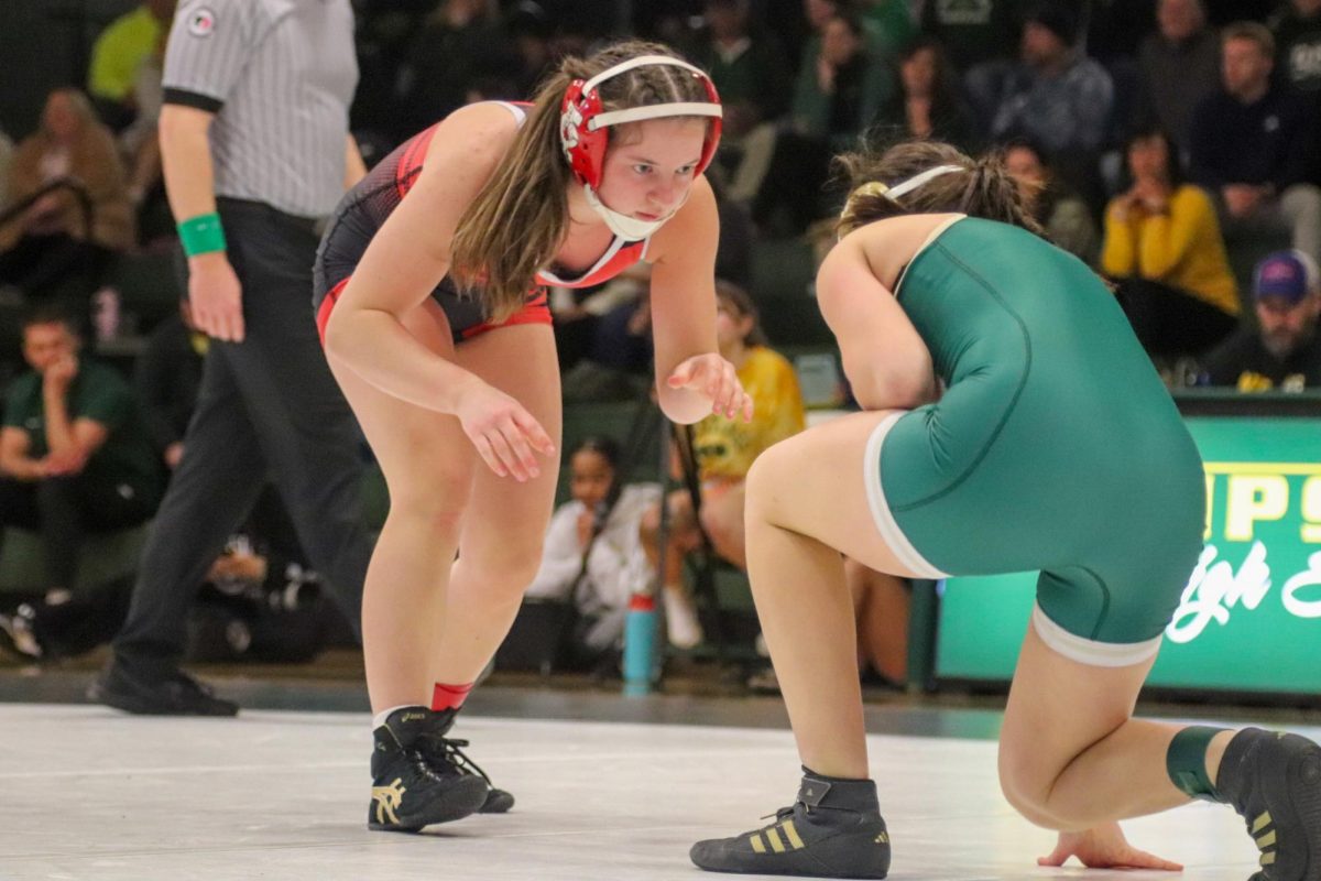 Eliza Mitchell '27 gets ready to pin her opponent down at a meet against Dubuque Hempsted.