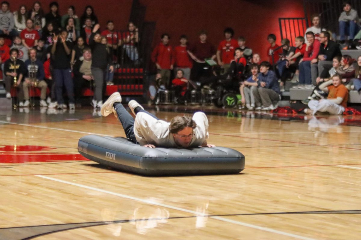 Kyle Evans '25 leaping, landing, and sliding on an inflattable mattress. This game was a crowd favorite as classes were separated into groups and aimed to push the mattress to the other side.