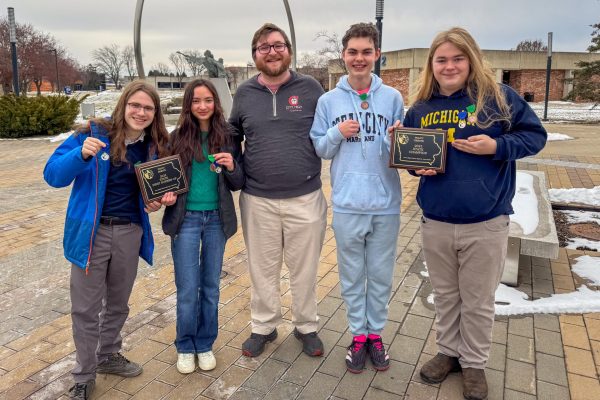 Toe Collins ‘26, Lily Rantanen '26, Coach Drew Gartner, Ethan Lalumiere ’25, and Kaj Larsen ‘25 hold their runner up and state champion plaques.