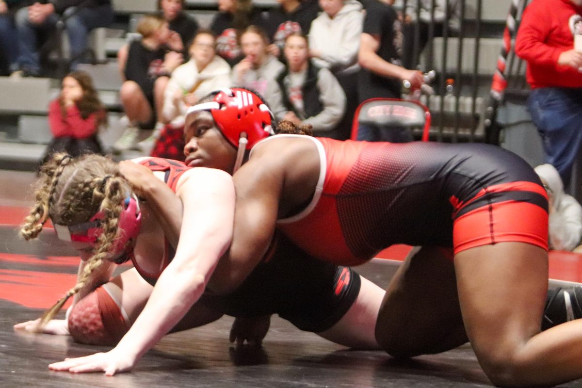 Shaona Emmanuel attempts to pin her opponent with a half nelson. She won her match by decision, 8-3.