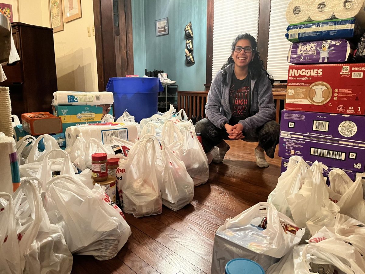 Alma Bhandary-Narayanan ‘26 poses with donations from the food drive.