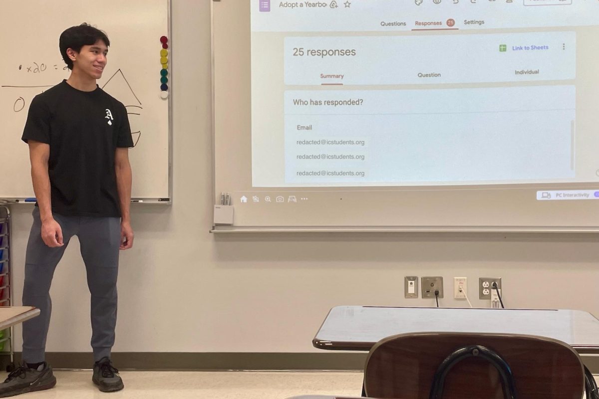 Student Senate President Nicholas Tran '25 goes over the Google Form students filled out for the Adopt a Yearbook program.