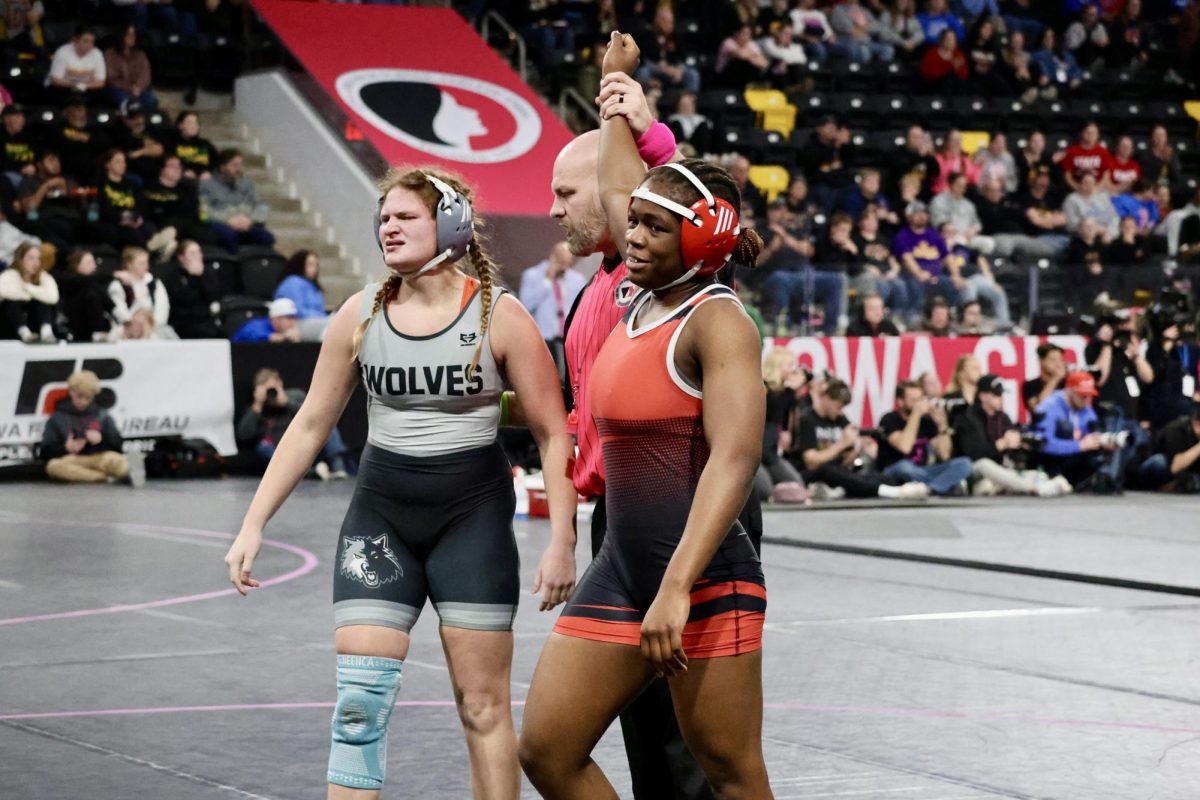 Emmanuel gets her hand raised after pinning her opponent for third.