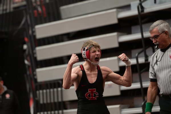 Kendall Kurtz'25 flexes after winning his 100th match of his career