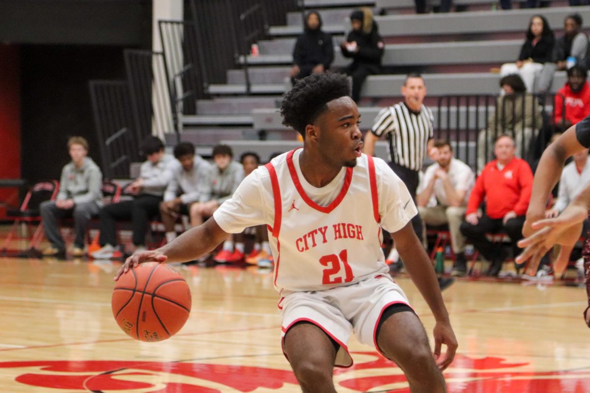 Davion Luckett '26 dribbles the ball down the court in a tight game against Waterloo West. The team went on to win 56-47.