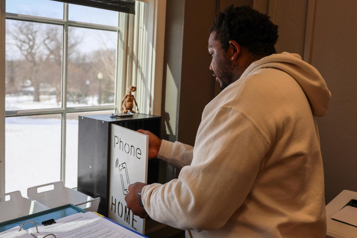 David Mayes-Butler secures a phone in the main office for the day after a student was caught with their phone out in class.