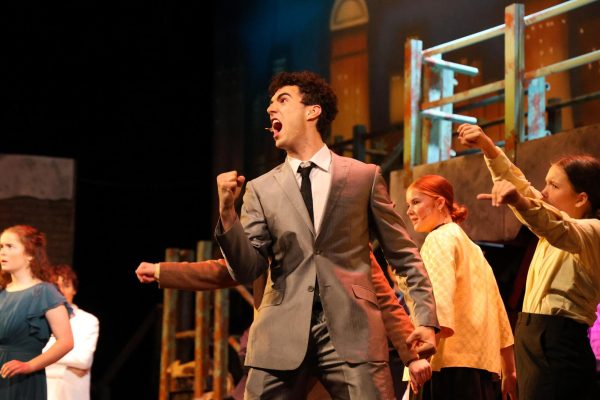 Brody Clarke '25 performs a song in the Urinetown musical