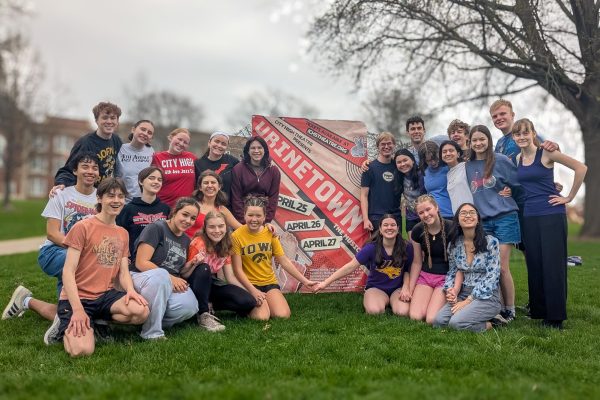Members of the cast and crew of Urinetown pose in front of City High promoting the musical.